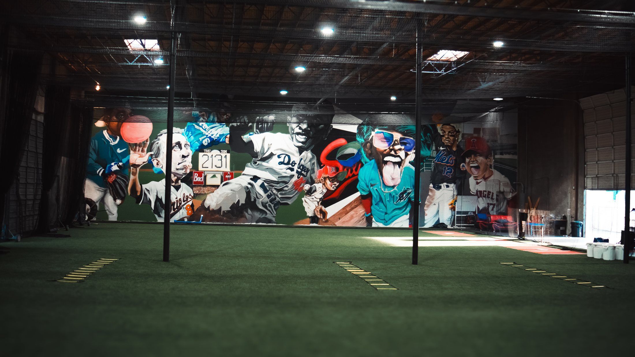 The painted baseball mural wall over empty turf at The Bears Den in Sacramento